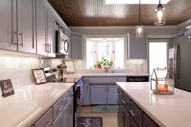 Gray bath vanity cabinets with white subway tiles. White Lace Quartz Premier Granite