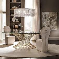 Sophisticated and refined dining rooms with these luxury italian extendable dining tables, ideal for elegant dining areas that need extra space.this contemporary italian furniture collection has luxurious high end extendable tables from italy with different high quality tops in wood, glass or ceramic and a wide variety of bases, materials and finishes. Luxury Italian Gold Plated Rings Glass Dining Table Set Juliettes Interiors Luxury Dining Tables Luxury Dining Room Dining Table Gold