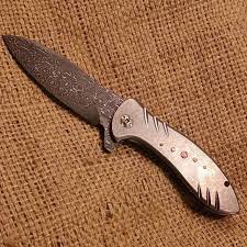 1/8 thick diamond blade, friction forged blade, devin thomas vines and roses damascus bolsters & blade inlay, 18 karat gold buttons, carved black lip mother of pearl scales and a titanium frame. Damascus Patterns From Billet To Finished Product Vegas Forge
