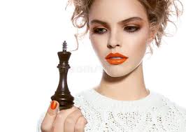 Beautiful Woman with Evening Make-up Holding a King Chess Piece Stock Photo 