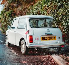 White Classic Mini With Red Minibib Classic Mini Mini Cooper Accessories Mini Magazine