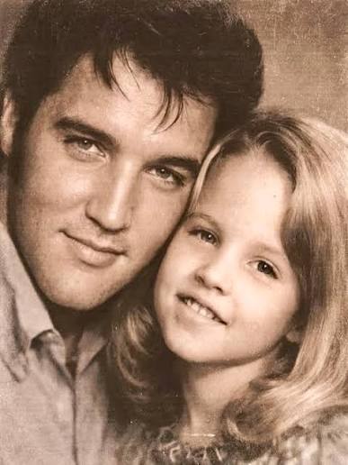 This iconic image shows Elvis Presley with his daughter, Lisa Marie, during  a family photo session. • Date: December 1970 • Event: A private family  portrait session (often cropped from a larger