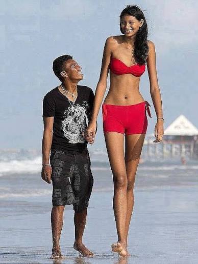 Brazil's tallest teen, Elisany da Cruz Silva, with her boyfriend,  Francinaldo da Silva Carvalho, in Salinopolis, Brazil. Standing at 6ft 8in,  Elisany has to bend down to kiss her 5ft 4in boyfriend