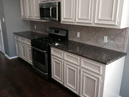 Titanium is an exotic black granite with swirls of gray and a caramel gold that create the perfect tie in for oak cabinets. Baltic Brown Kitchen White Cabinets Houston By Great Priced Granite Houzz