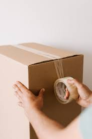 Fold the flap of tape down and press it firmly to the cardboard. Crop Man Sealing Carton Box With Tape Free Stock Photo