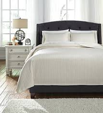 The upholstered bed is dramatic and inviting. Birlanny Queen Panel Bed Ashley Furniture Homestore