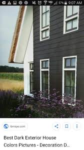 Dark grey siding with white trim, choosing exterior house colors on a lakeside cottage. Dark Grey White Trim Black Windows Outside House Paint Colors Outside House Paint Farmhouse Exterior