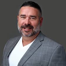 JOHN SCHULTZ — Phelps Construction Group, LLC