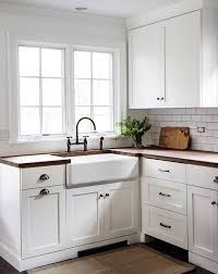 Simple Classic Country Cottage Kitchen With White Cabinetry And Timber Benchtops White White Shaker Kitchen Cabinets White Kitchen Design White Shaker Kitchen