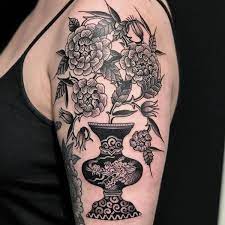 Flowers In Dragon Pot Tattoo By El Dragon Eldragon Planttattoos Blackandgrey Linework Flowers P Traditional Tattoo Vase Elegant Tattoos Black Ink Tattoos