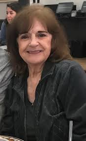 This is a picture of a dear friend of mine who just passed away. We would  like to use just her for the obituary. Can you delete everything out around  her and