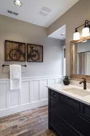 You should consider for such the interesting choice for the entire home such by having the wainscoting. Wall Panels Bathroom Powder Room Transitional With Framed Art Wood Floor Towel Bar Wood Like Tile Boys Bathroom Bathrooms Remodel