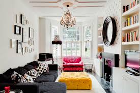 The simple living room area has modern black leather furniture, a gas fireplace, and modular wooden coffee tables. Black Furniture Interior Design Photo Ideas Small Design Ideas