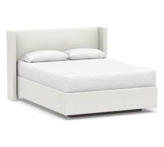 The classic style and elegant design of the bed is a statement. Elliot Shelter Upholstered Headboard With Footboard Storage Platform Bed King Basketweave Slub Ivory Pottery Barn Havenly