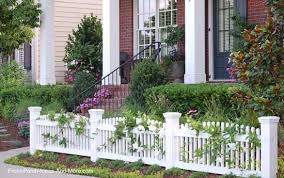 Points of interest gravel and soil box with white wheelbarrow planter plastic convex picket fence red and yellow perennial flowers. Picket Fence Ideas For Instant Curb Appeal Picket Fence Garden Front Yard Fence Yard Fence Ideas
