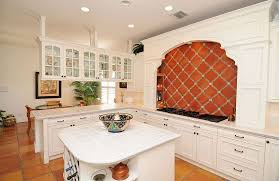 A spanish kitchen with a large cooker, a printed backsplash, gold touches, dark furniture and lamps with a vintage feel a spanish living room with a wooden ceiling with beams, white walls and a fireplace, neutral furniture and dried blooms Spanish Colonial Kitchen Cabinets Etexlasto Kitchen Ideas