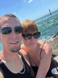 Keep warm in style with this classic black peacoat. • Size: Small • Color:  Black exterior with a vibrant purple lining • Style: Double-breasted front  with 6 buttons • Fit: Tailored seams