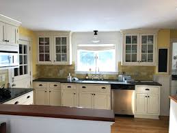 The house is 22 years old and we want to spruce it up, get rid of wall paper and perhaps use granite instead of the white lami. Cream Cabinets Black Counter Tops One Hundred Dollars A Month