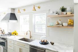Kitchens do not need to be huge to be beautiful and functional. White And Gold Kitchen With Black Range Hood Contemporary Kitchen