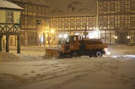 Camel tows car out of the snow. Heavy Snowstorm Pounds Germany Upends Travel