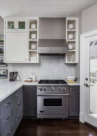 White And Gray Kitchen Features White Upper Cabinets And Distressed Gray Lower Cabinets Paired Stylish Small Kitchen Small Kitchen Layouts Kitchen Design Small