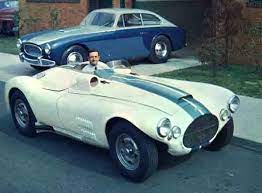 Briggs Cunningham At The Wheel Of The C 4r Its Civilian Version The C 3 In The Background Classic Sports Cars Sports Car Racing Road Race Car