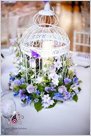 You can even grow vines in it. Floral Birdcage Purple Birdcage Wedding Bird Cage Decor Flower Arrangements Bird Cage Centerpiece