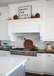 Rustic kitchen cabinets run the full style spectrum this spring, from french provincial to pacific rustically yours: Picture Of A White Rustic Kitchen With Shaker Cabinetry A Grey Kitchen Island And A Hidden Hood Covered Like A Cabinet