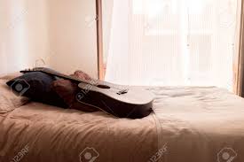 Gearmy bedroom setup gear (self.guitar). Black Acoustic Guitar On A Bed A Sunny Day In A Beautiful Room Stock Photo Picture And Royalty Free Image Image 159883188