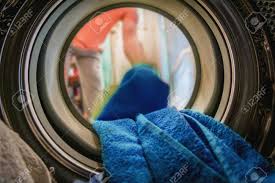 Washing like colors together not only prevents unwanted pink underwear, but it also keeps colors from fading. Man Putting Color Clothes Into Washing Machine Inside View Stock Photo Picture And Royalty Free Image Image 80059896