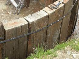 Using Upright Railway Sleepers As A Retaining Wall This Is Your Chance To Grab 100 Great Building A Retaining Wall Landscaping Retaining Walls Railway Sleepers