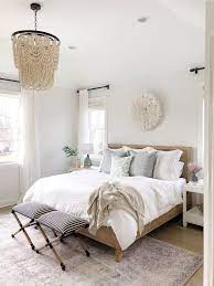 Neutral Bedroom Features Beaded Chandelier Vintage Inspired Rug White Bedding And Tassel Pillows Neutral Bedroom Decor Bedroom Interior Master Bedrooms Decor