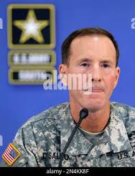 Brooke Army Medical Center Commander Brig. Gen. Jeffrey Johnson and Command  Sgt. Maj. Albert Crews present U.S. Army South Command Sgt. Maj. Carlos  Olvera a copy of the Hispanic Heritage Month proclamation