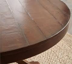 A circular dining table that expands when rotated. Benchwright Round Pedestal Extending Dining Table Pottery Barn