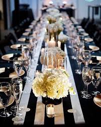 Black And White Striped Table Runner With Candles And Bowls Of Full Roses In This Wedding Venue Styling White Wedding Flowers Gold Wedding Wedding Decorations
