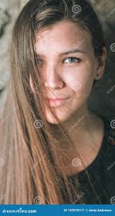 Close-up Portrait of a Beautiful Girl with Long Flowing Hair Covering One  Eye. a Young Woman Looks Straight into the Stock Image