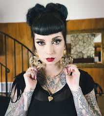 I will always be wearing giant earrings and lots of jewelry. But I have a  constant push/pull between nude lips and red. But now I'm bringing black  back into the mix and