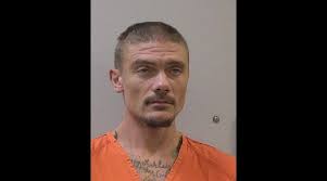 Man arrested as person of interest in death investigation charged with  murder