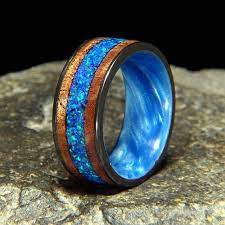 10 Mm Wide Black Zirconium Exterior With Blue Pearl Swirl Interior 2 2 5 Mm Curly Koa Outer Bands With A 50 Pacific Blue Blue Pearl Blue Opal Ring Designs