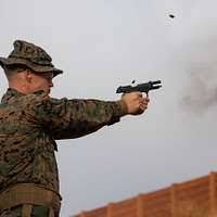Retired Master Sgt. Richard Thomas fires his pistol