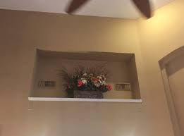 Clark used touches of black on the frames, lamp shade trim and pillow to help tie the black tv in.) How To Decorate Wall Niches Both Large And Small Designed