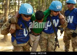 U.N. Peacekeepers from the U.S. Army 728th Military Police Battalion move a  wounded civilian role-player during a mass casualty event in a field  training exercise as part of Exercise Shanti Doot 4