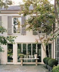 Black And White Painted Brick House Shutter Speed The Potted Boxwood Painted Brick House House Exterior Exterior Paint