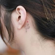 Hakuna matata upper back tattoo. Minimalist Hakuna Matata Symbol Tattoo Behind The Ear