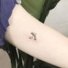 For a tribal dolphin tattoo, try a dolphin with only the top half done in the razor wire pattern and the bottom half colored in grey. 1