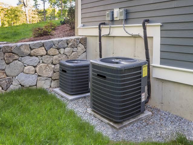 AC technician repairing an air conditioning unit