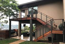 It makes use of a luxurious panel fencing which is in a lovely dark wooden brown color and complements the interiors and lights well. Modern Outdoor Stair Railing Designs And Ideas That Actually Make Sense