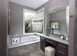 A super refined moody bathroom with chocolate brown walls, grey paneling, a chic tub on a marble. Grey Brown Bathroom Ideas Houzz