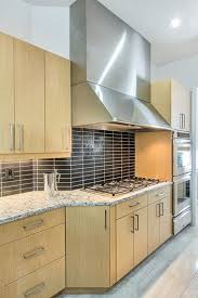 The black island with a white quartz countertop creates a light. Fun With Backsplash And Grout Kitchen Design Concepts