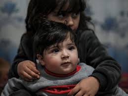 Joy as baby given to US soldier during Afghan withdrawal is reunited with  relatives